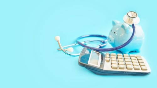 Calculator, piggy bank & stethoscope grouped together on the right side of blue background